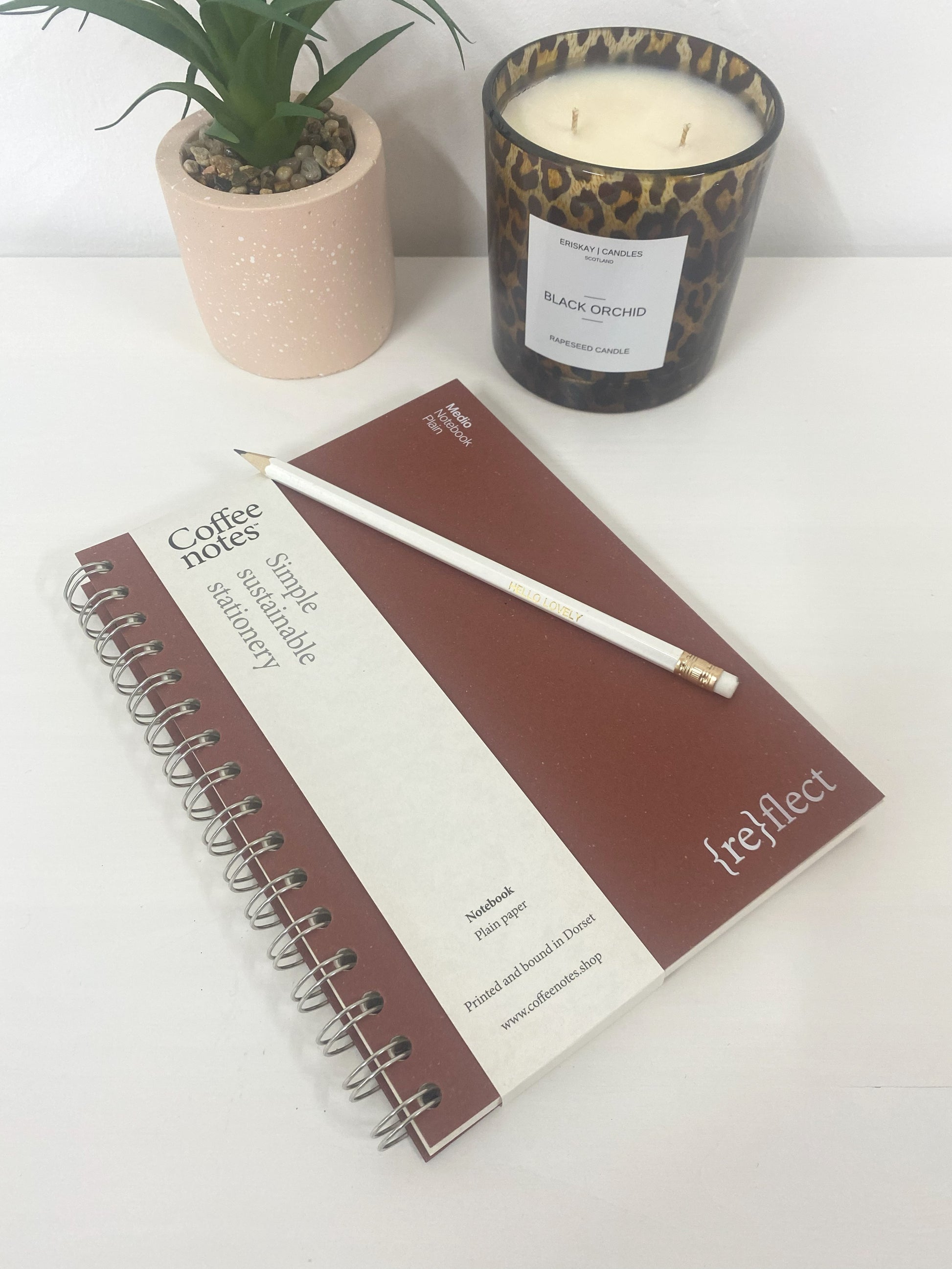 Recycled brown note book on desk with pencil